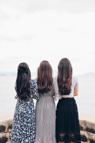 Three women wearing dress