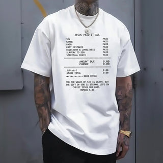 Person wearing a Jesus Paid it all white t-shirt with tattoos on arms and neck.