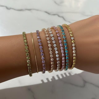 Colorful beaded bracelets on a wrist with a blurred background