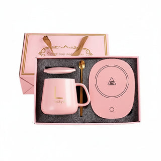 Pink ceramic set with mug, saucer, and spoon in a decorative box.